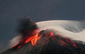 Volcano erupting at night